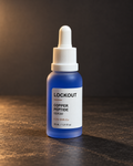 Lockout serum in a blue frosted bottle with white dropper on charcoal background. Retouched product photo.
